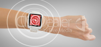Composite image of cropped image of woman hand wearing smart watch
