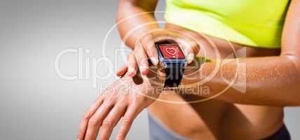 Composite image of close up on a sportswoman wearing a connected watch