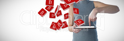 Composite image of mid section of businesswoman using digital tablet