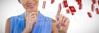 Composite image of smiling businesswoman with hand on chin touching interface