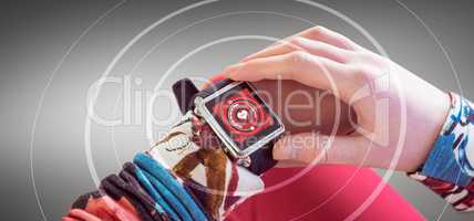 Composite image of woman using smart watch