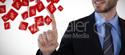 Composite image of mid section of smiling businessman touching invisible screen