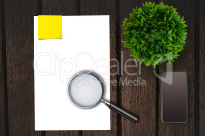 Magnifying glass on paper on the side of smartphone