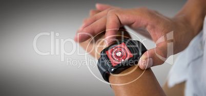 Composite image of cropped image of man using smart watch