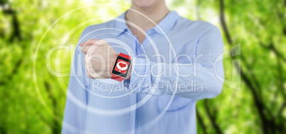 Composite image of businesswoman wearing smartwatch