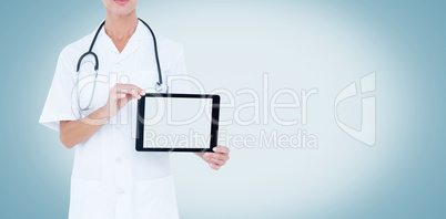 Midsection of female doctor showing digital tablet