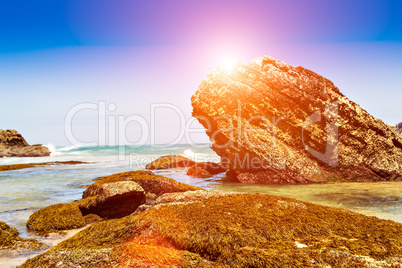 Sunset rocks on beach.