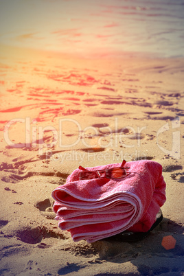 Beach towel on sand.