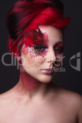 Young girl with red hair and creative ingenious makeup