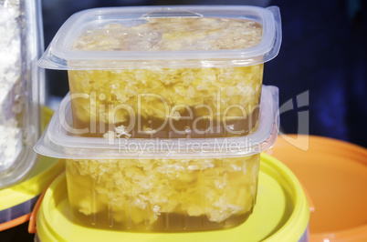 Honey and honeycomb in small containers.