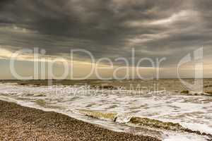 sullen red sea covered  dark clouds