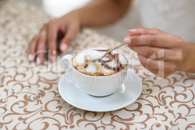 the bride's stirring a cappuccino