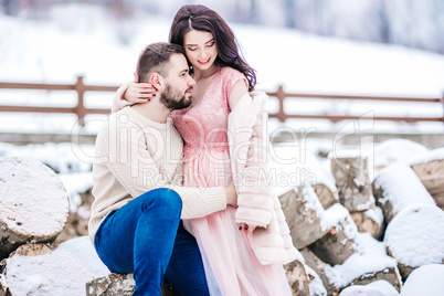 young couple on a walk in the snowy mountains