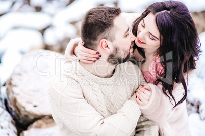 young couple on a walk in the snowy mountains