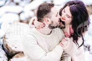 young couple on a walk in the snowy mountains