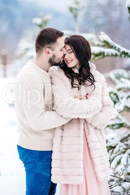 young couple on a walk in the snowy mountains