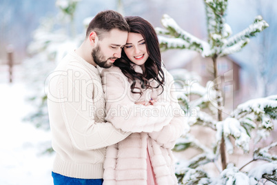 young couple on a walk in the snowy mountains