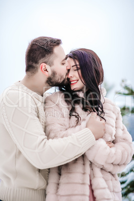 young couple on a walk in the snowy mountains