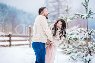 young couple on a walk in the snowy mountains