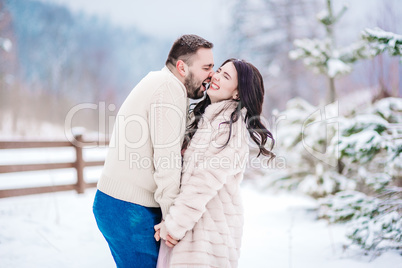 young couple on a walk in the snowy mountains