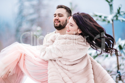 young couple on a walk in the snowy mountains