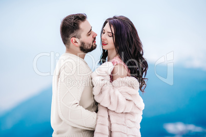 young couple on a walk in the snowy mountains