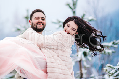 young couple on a walk in the snowy mountains