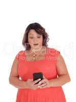Woman looking surprised at her cell phone