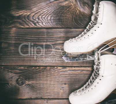 a pair of white leather skates