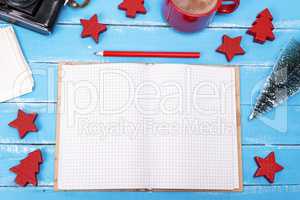 open blank notebook with a red pencil