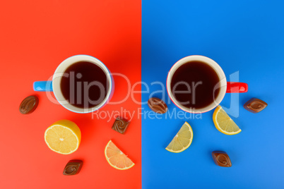 Red and blue cups with tea on a red and blue background. Flat la