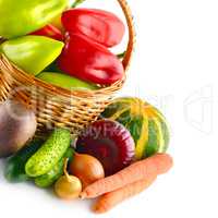 Set of vegetables in wicker basket isolated on white background.