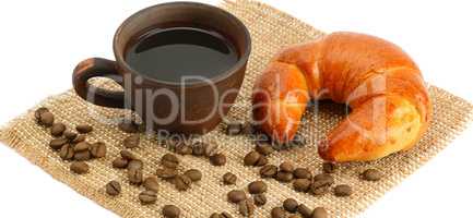 Croissant and coffee isolated on white background . Wide photo.