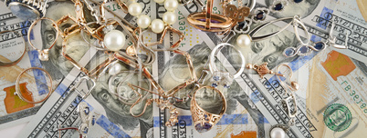 Background of American dollars and jewelry. Flat lay, top view.