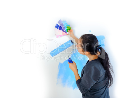 girl picks up the color of paint for painting