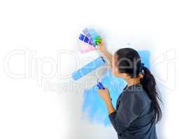 girl picks up the color of paint for painting