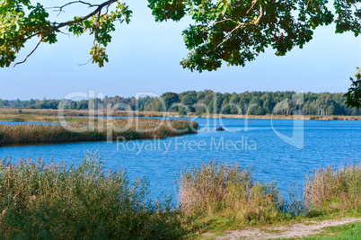 lake or pond for fishing, the fishermen on the boat, the scenery is beautiful pond