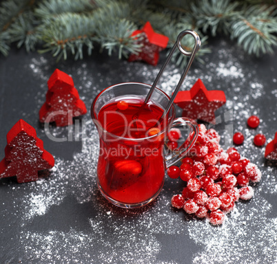 tea from fresh red viburnum in a transparent glass