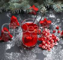 tea from fresh red viburnum in a transparent glass