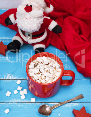hot chocolate in red ceramic mug with marshmallow