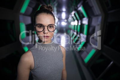 Confident female executive standing in futuristic office