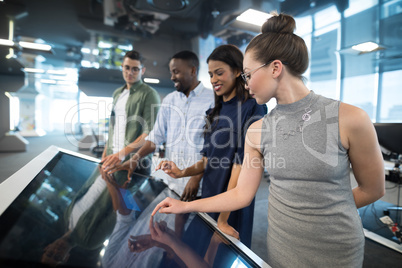 Business executives touching digital screen