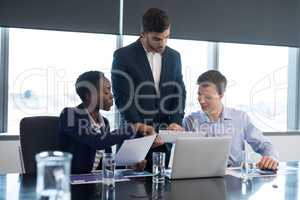 Executives discussing over documents
