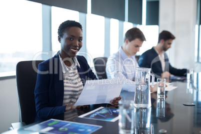 Portrait of female executive holding graph