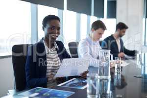 Portrait of female executive holding graph