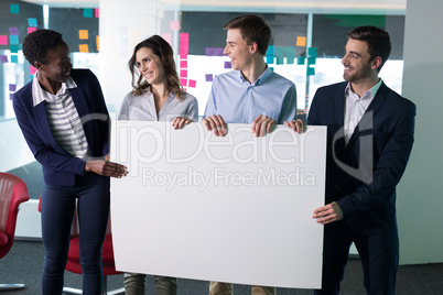 Happy executives holding a blank banner