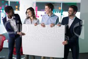 Happy executives holding a blank banner