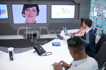 Male and female executives having video call