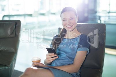 Portrait of female executive using mobile phone