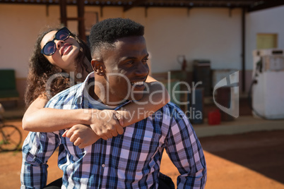 Man giving a piggyback ride to woman